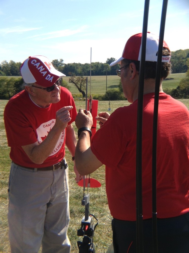 Peter Cook (left) and Sav Prato loading a swing-wing boost glider for launch.